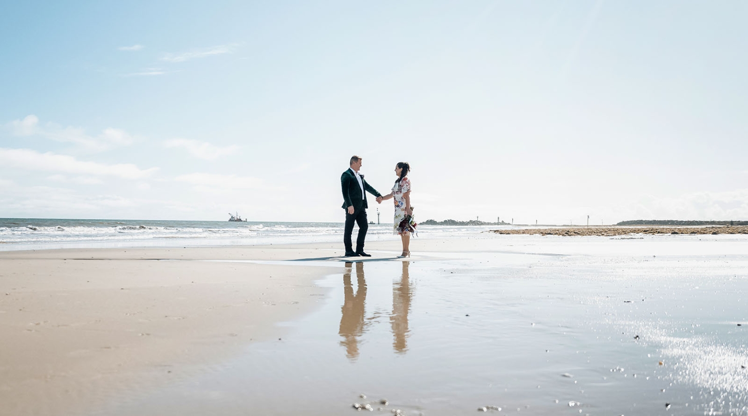 sa marriage office wedding – melissa & kyran 223 Romantic beach wedding portrait of couple holding hands by ocean waves.