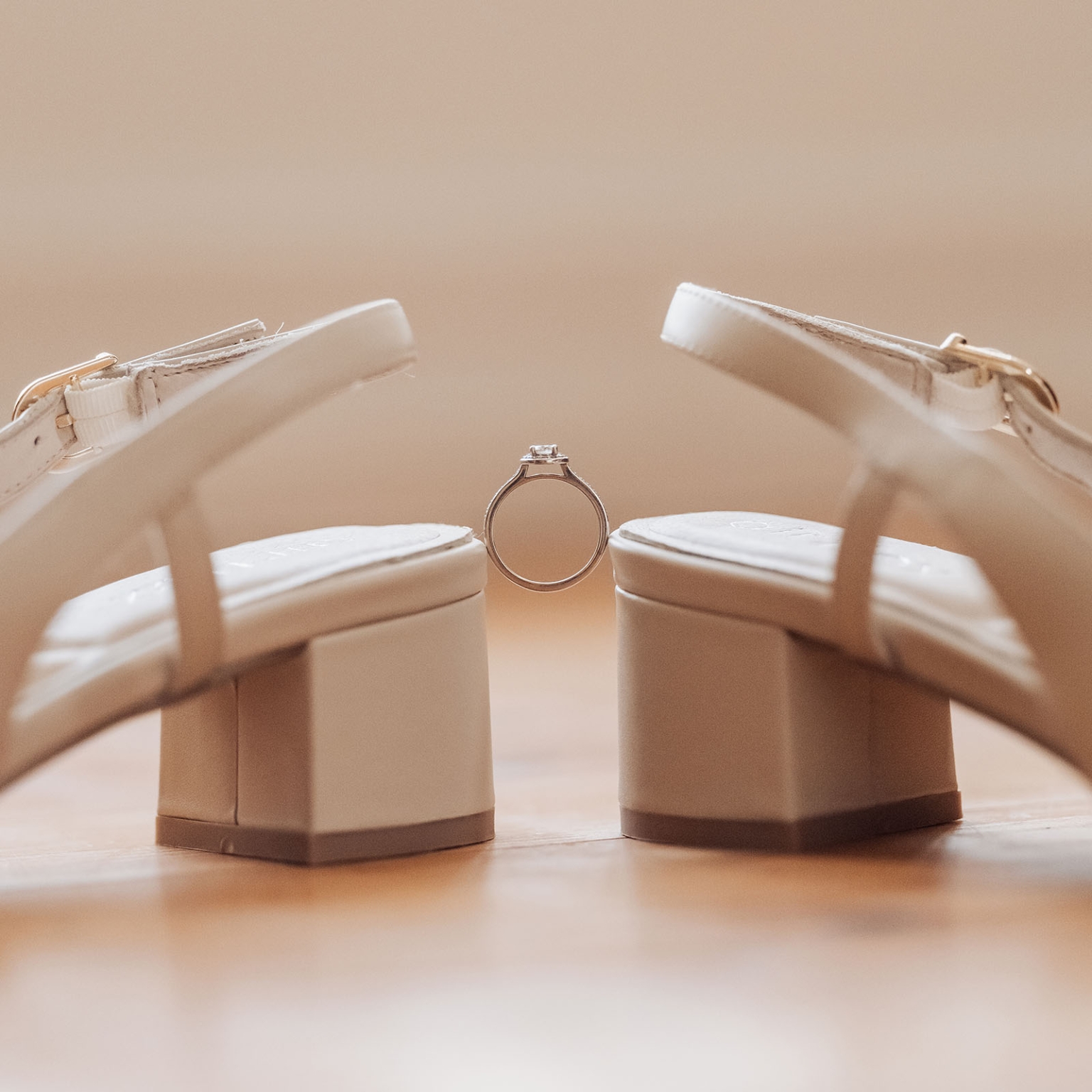 loxton's st peter's church wedding - madeline & brayden 14 Bridal heeled sandals with diamond engagement ring on wooden surface.