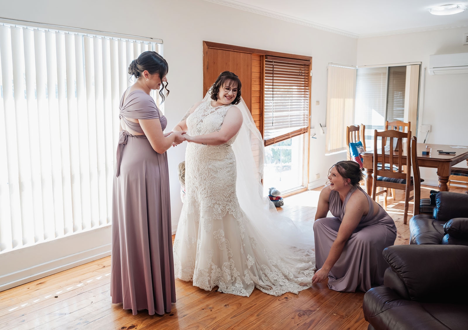 loxton's st peter's church wedding - madeline & brayden 25 Bride and bridesmaids getting ready, adjusting lace wedding gown and veil.