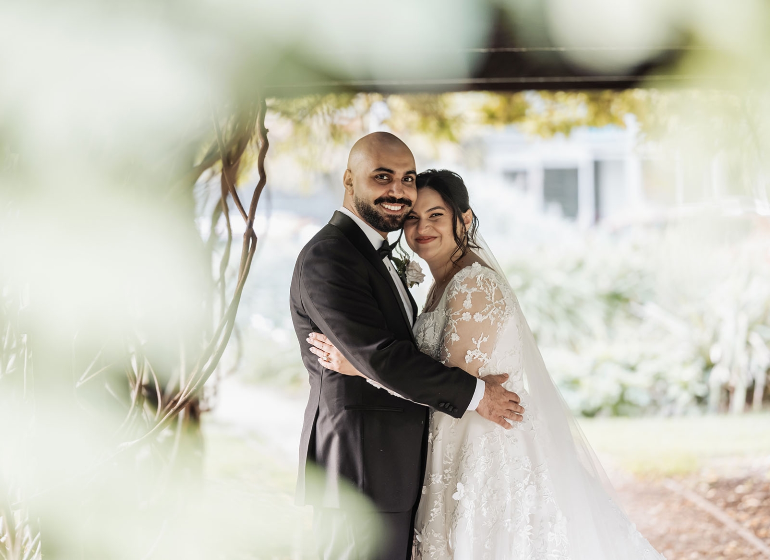 st george & st shenouda coptic church wedding - carmina & bill 66 Bride and groom outdoor wedding portrait in lush garden.