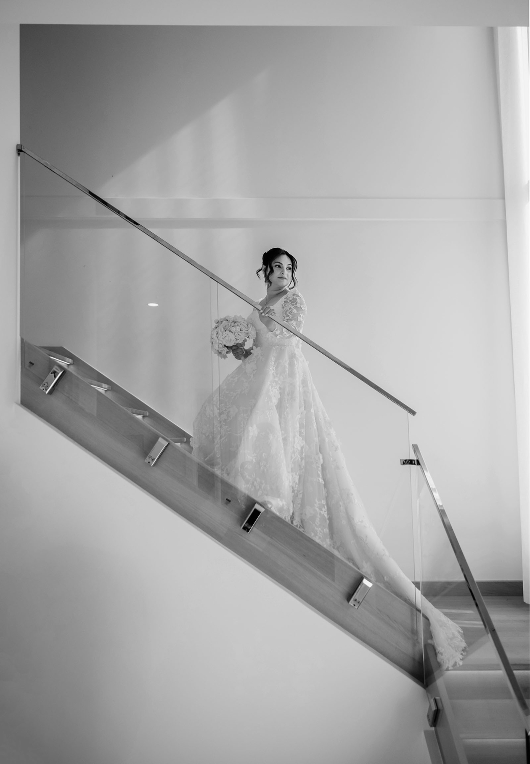 st george & st shenouda coptic church wedding - carmina & bill 30 Bride in lace wedding gown on modern staircase with bouquet.