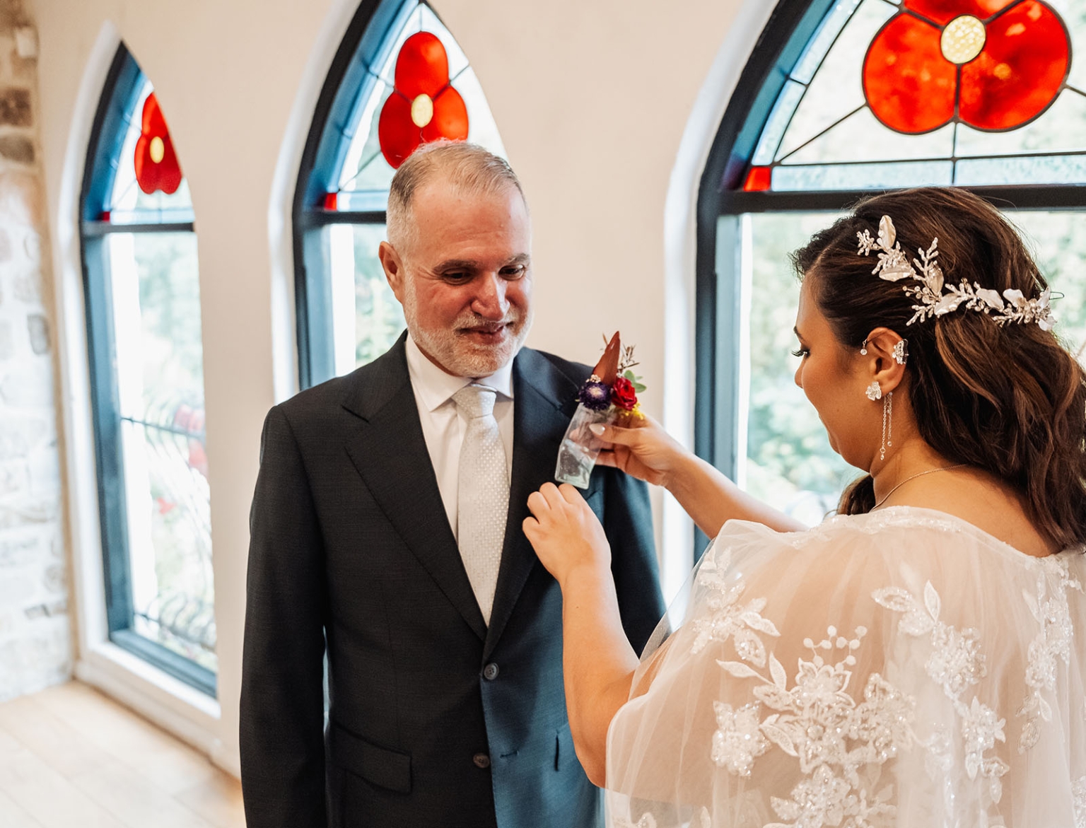 basket range wedding at the manor - leah & wes 14 Bride pinning boutonniere on father before wedding ceremony in stained glass chapel.