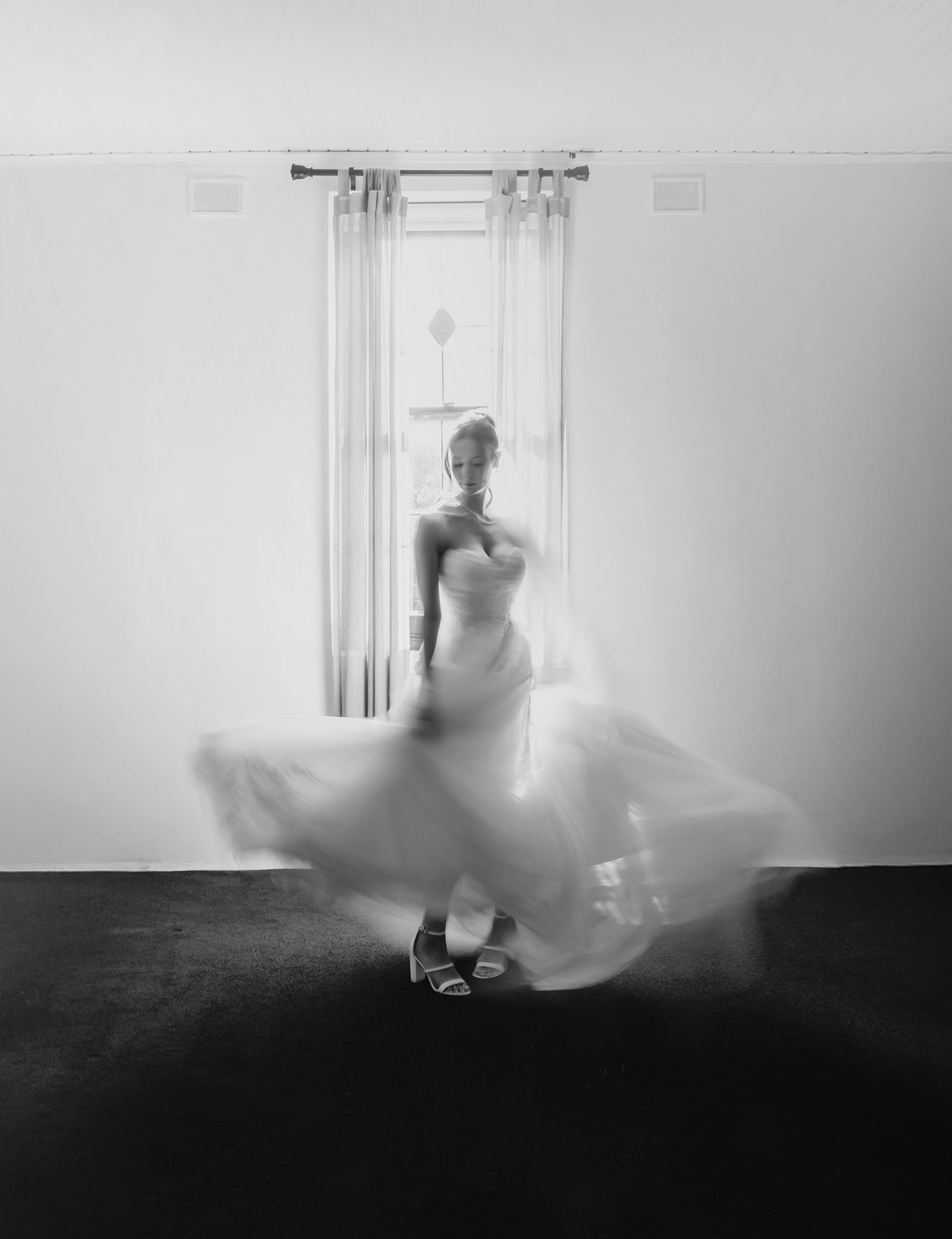 the manor wedding - crystal & mackenzie 26 Bride twirling in strapless wedding dress by bright window light.