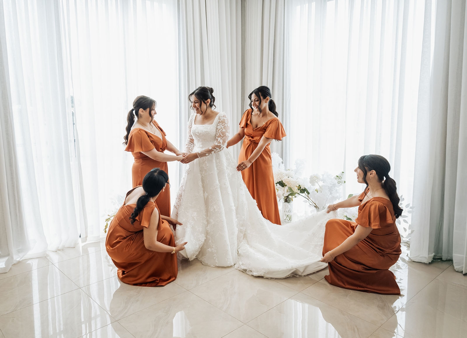 st george & st shenouda coptic church wedding - carmina & bill 25 Bride in lace wedding dress with burnt orange bridesmaids preparing gown.