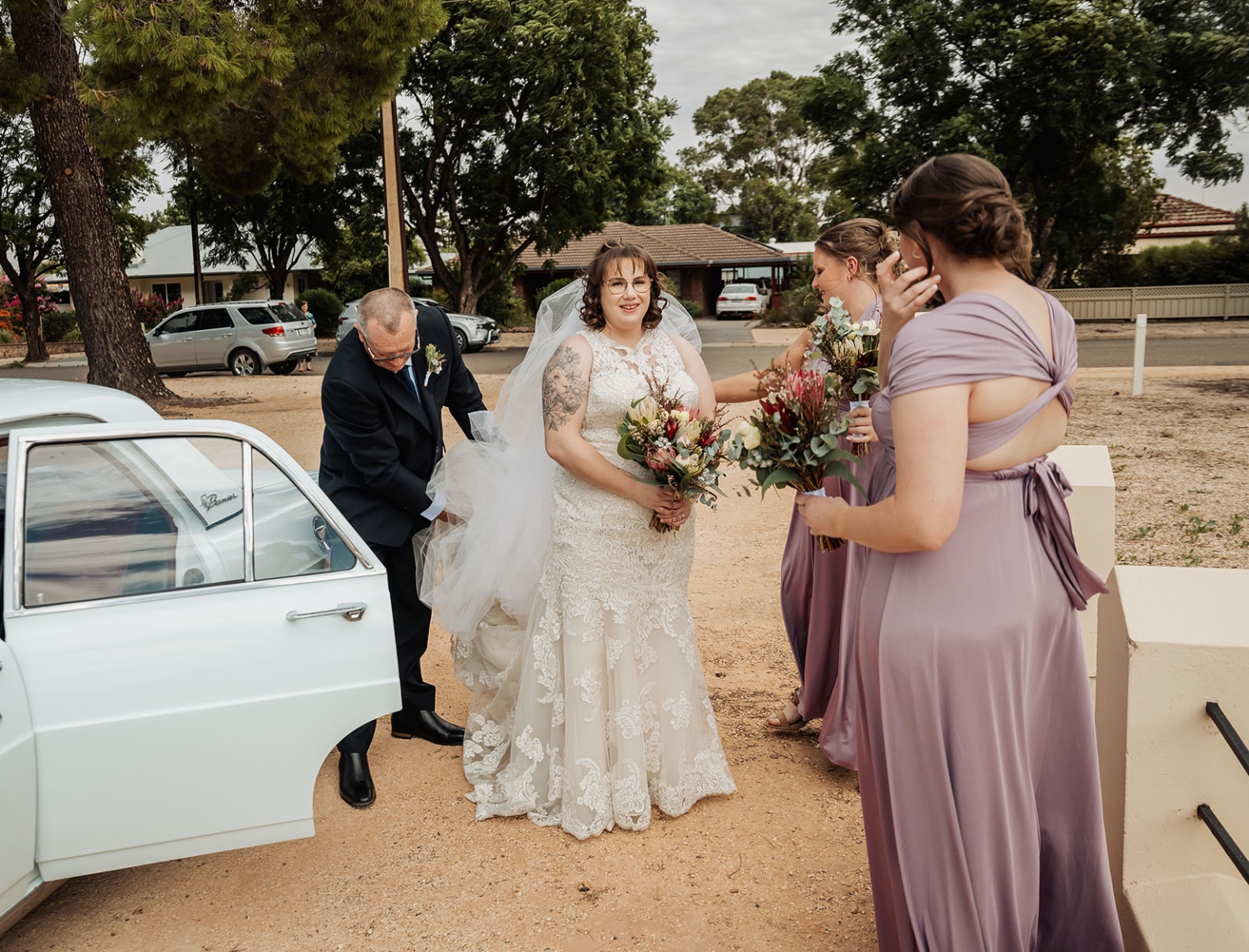 loxton's st peter's church wedding - madeline & brayden 29 Bride with vintage wedding car and bridesmaids holding bouquets.