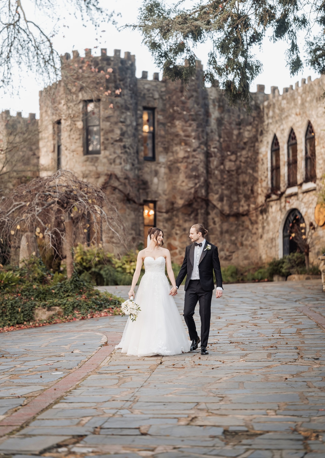 the manor wedding - crystal & mackenzie 75 Bride and groom in castle wedding portrait on romantic stone garden path.