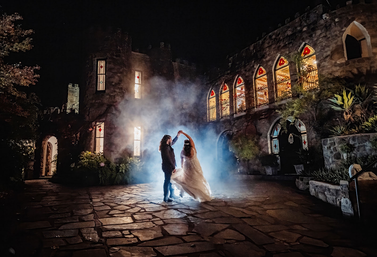 basket range wedding at the manor - leah & wes 65 Romantic castle wedding dance with bride and groom in moonlit courtyard.