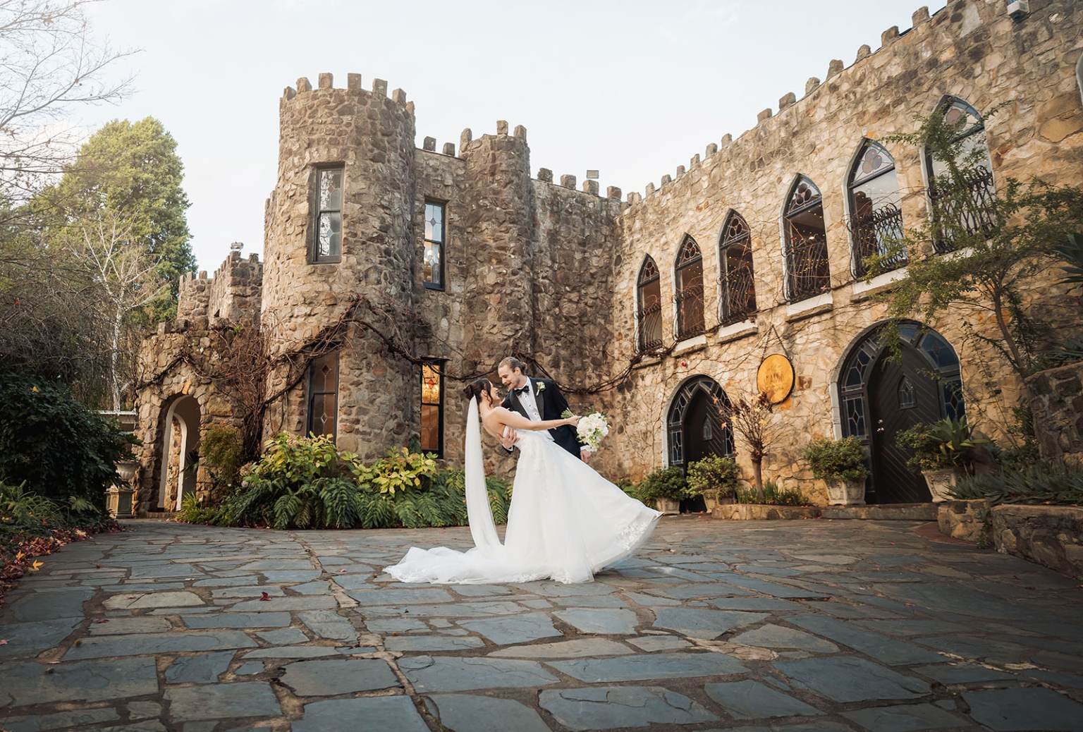 the manor wedding - crystal & mackenzie 76 Bride and groom in fairytale castle courtyard wedding portrait.