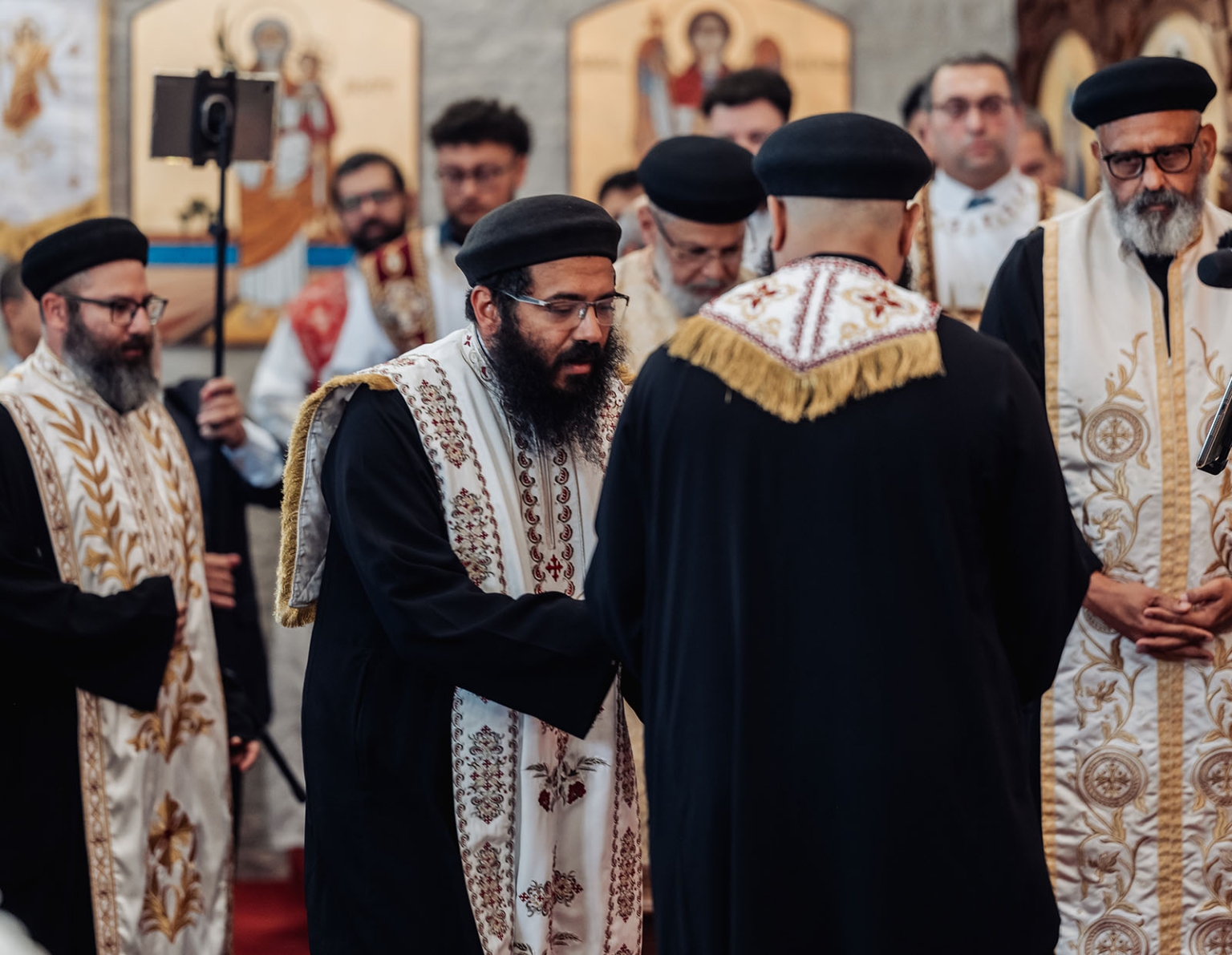 st george & st shenouda coptic church wedding - carmina & bill 38 Coptic Orthodox clergy perform a solemn church ceremony in ornate embroidered vestments.