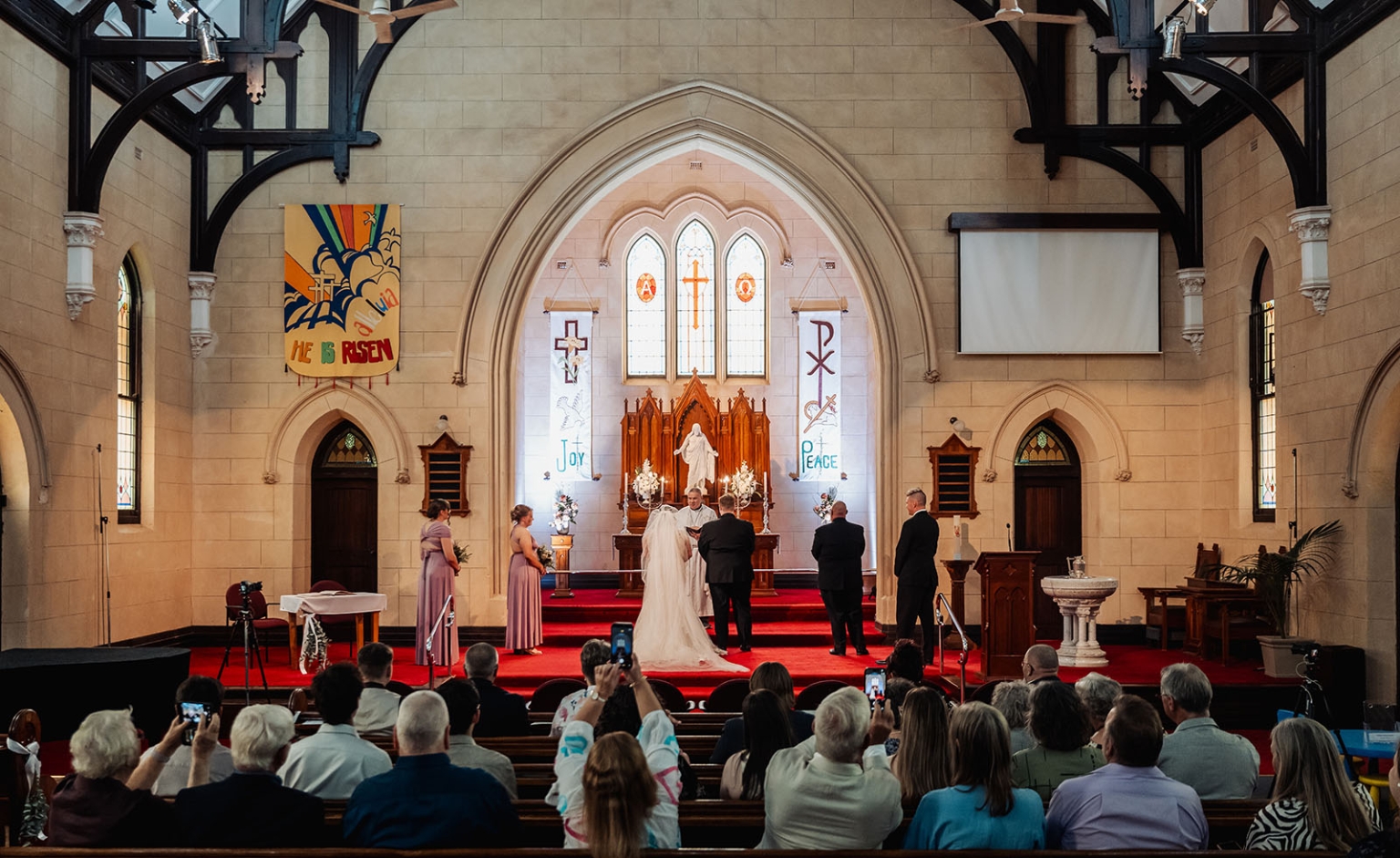 loxton's st peter's church wedding - madeline & brayden 32 Church wedding ceremony with bride and groom at Gothic altar.