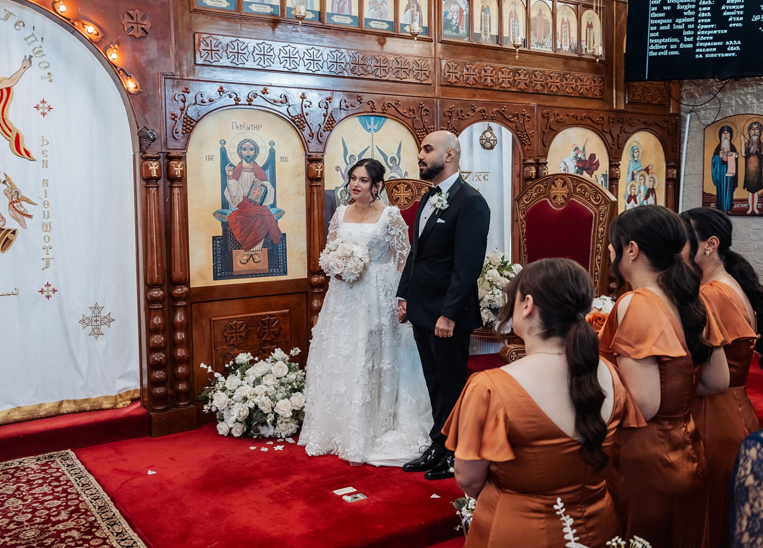 st george & st shenouda coptic church wedding - carmina & bill 37 Orthodox church wedding ceremony with bride, groom, icons, bridesmaids, and floral altar.