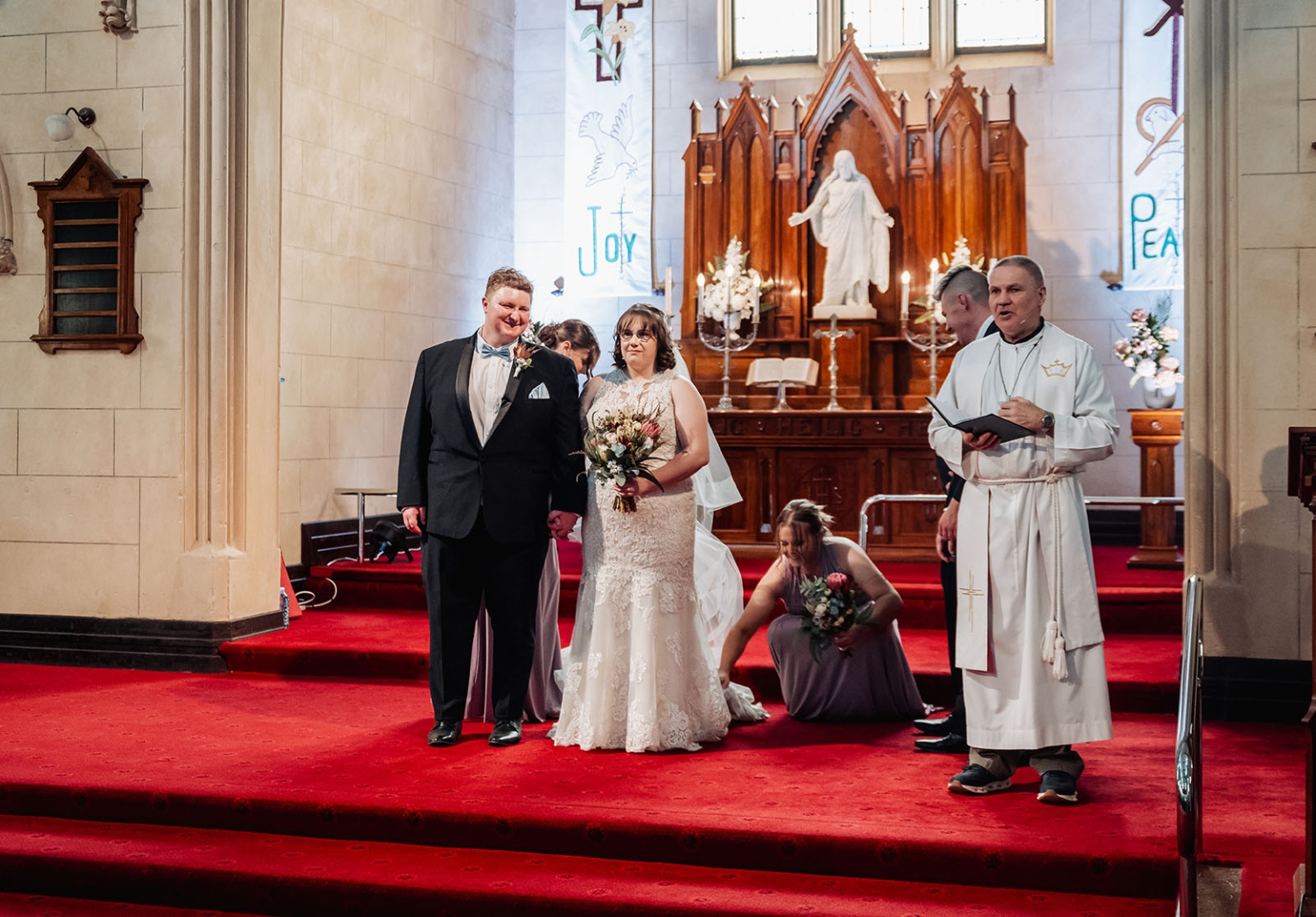 loxton's st peter's church wedding - madeline & brayden 39 Bride and groom at church wedding ceremony on red carpet altar.