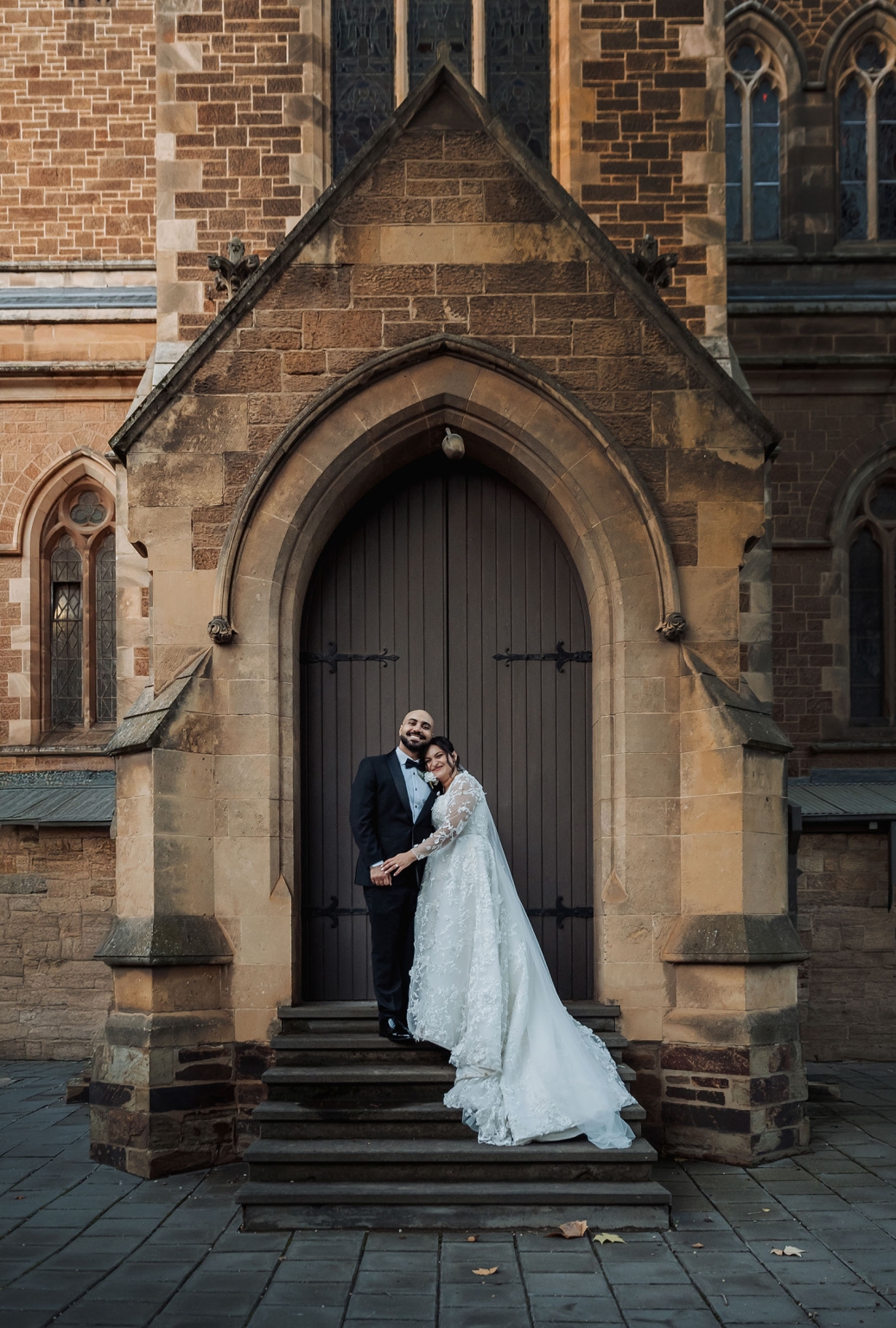 st george & st shenouda coptic church wedding - carmina & bill 71 Bride and groom wedding portrait on Gothic church cathedral steps.