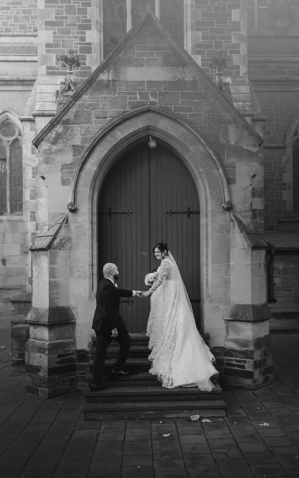 st george & st shenouda coptic church wedding - carmina & bill 70 Bride and groom wedding portrait at Gothic church entrance.
