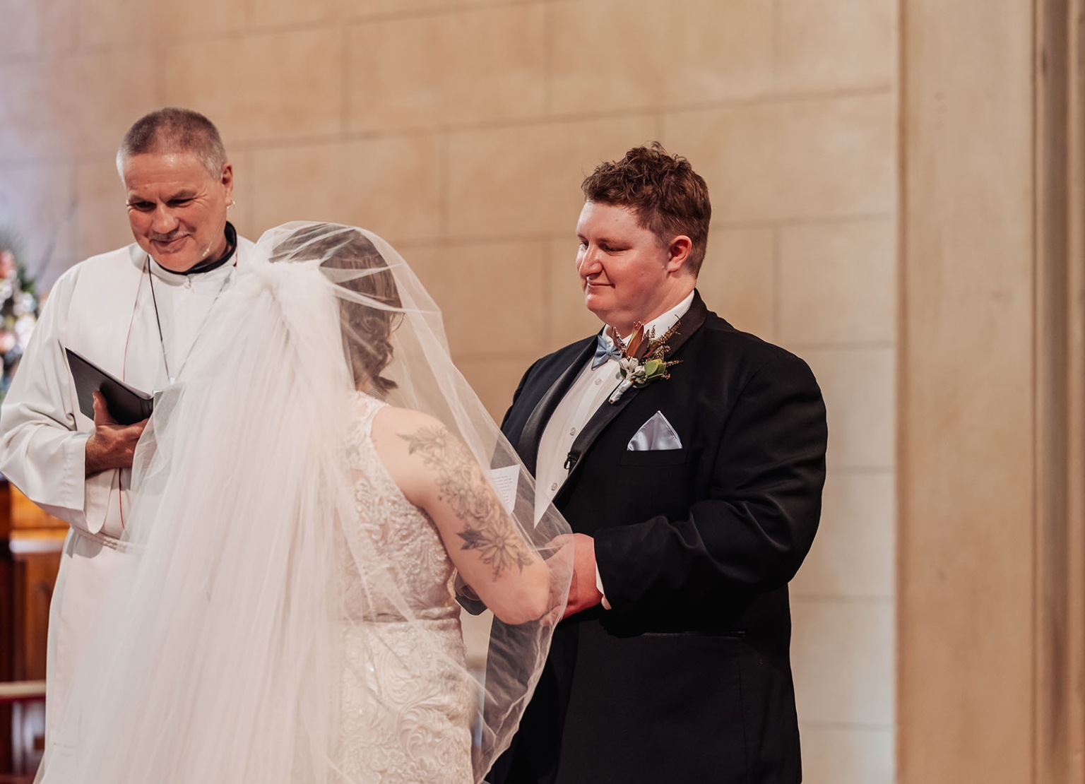 loxton's st peter's church wedding - madeline & brayden 35 Couple exchanging wedding vows in church with officiant at altar.