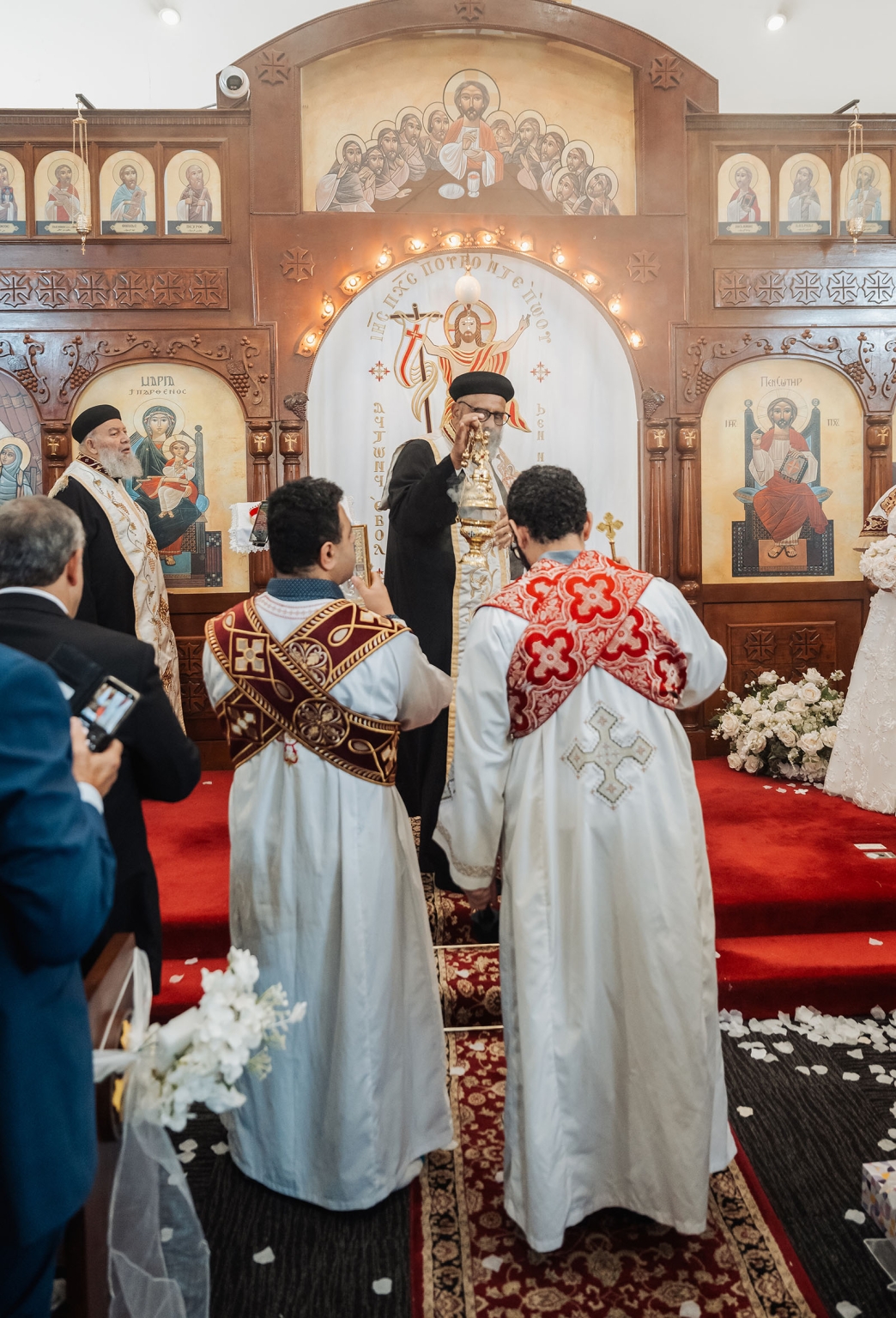 st george & st shenouda coptic church wedding - carmina & bill 44 Coptic church wedding ceremony with priests before ornate altar.