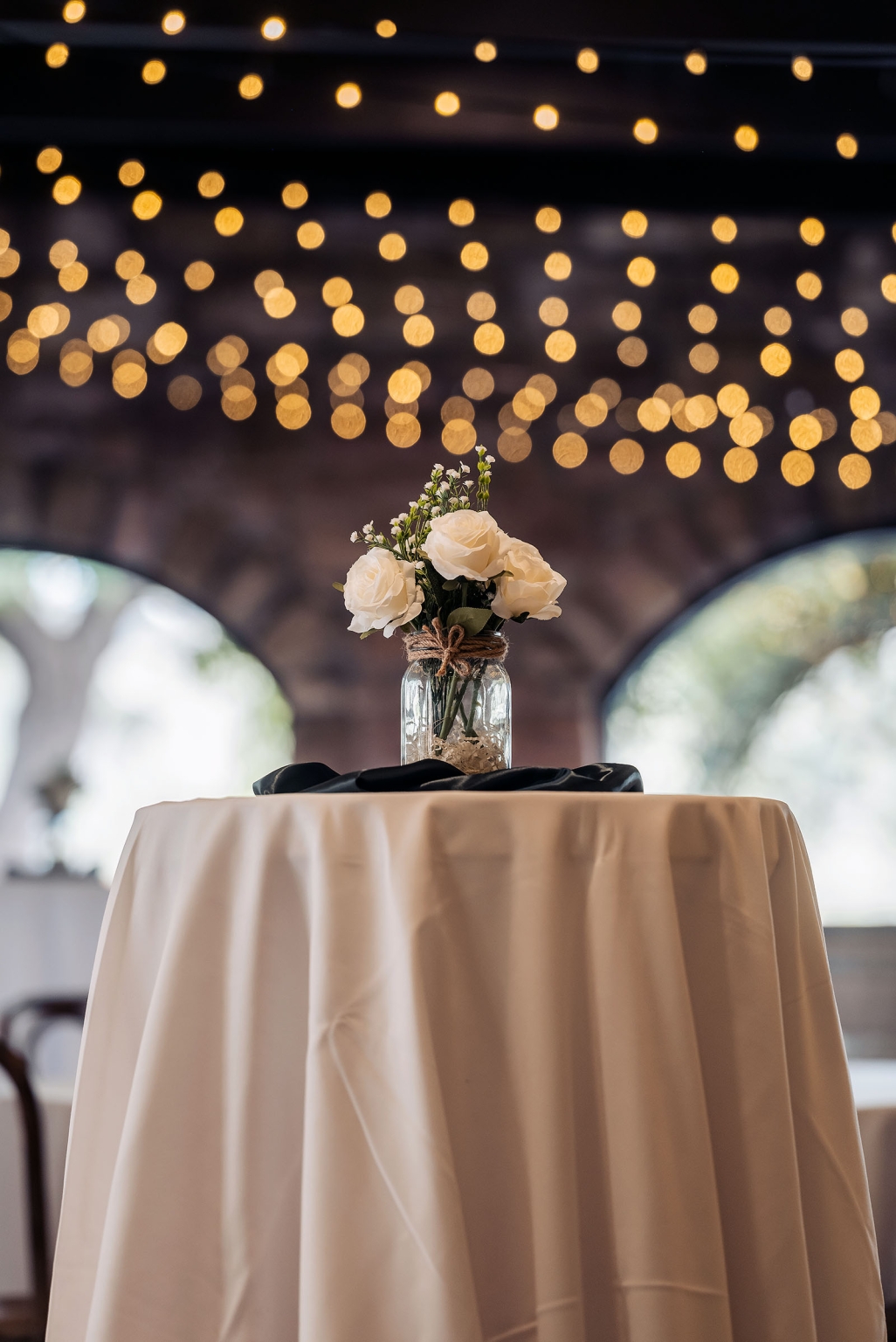the manor wedding - crystal & mackenzie 85 Rustic white rose wedding centerpiece in mason jar on elegant reception table.