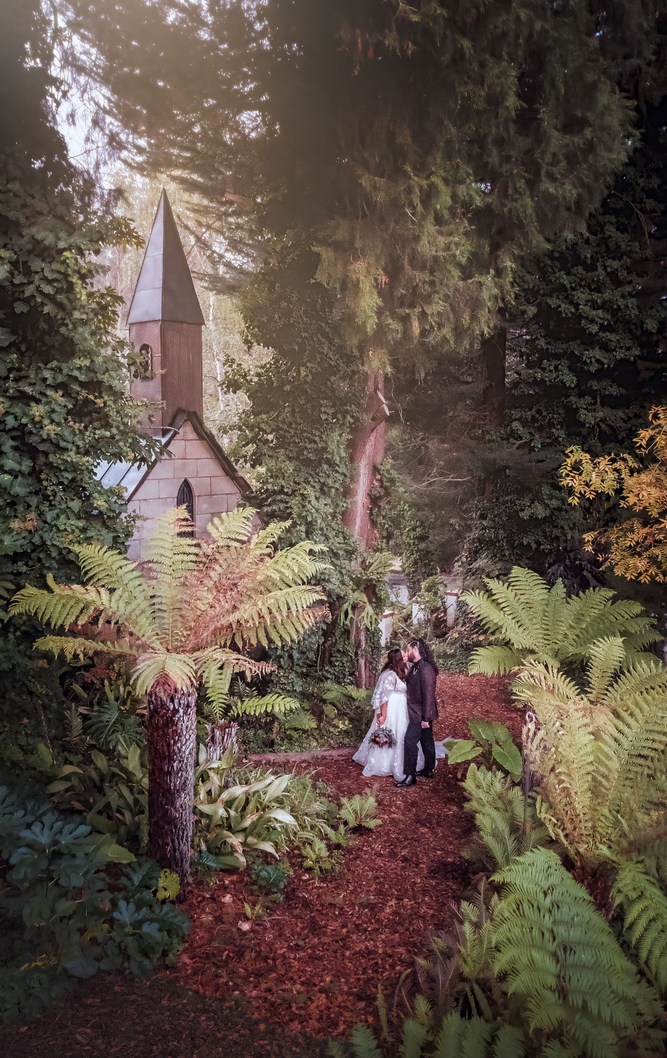 basket range wedding at the manor - leah & wes 63 Forest garden wedding kiss beside a hidden chapel in a lush woodland.
