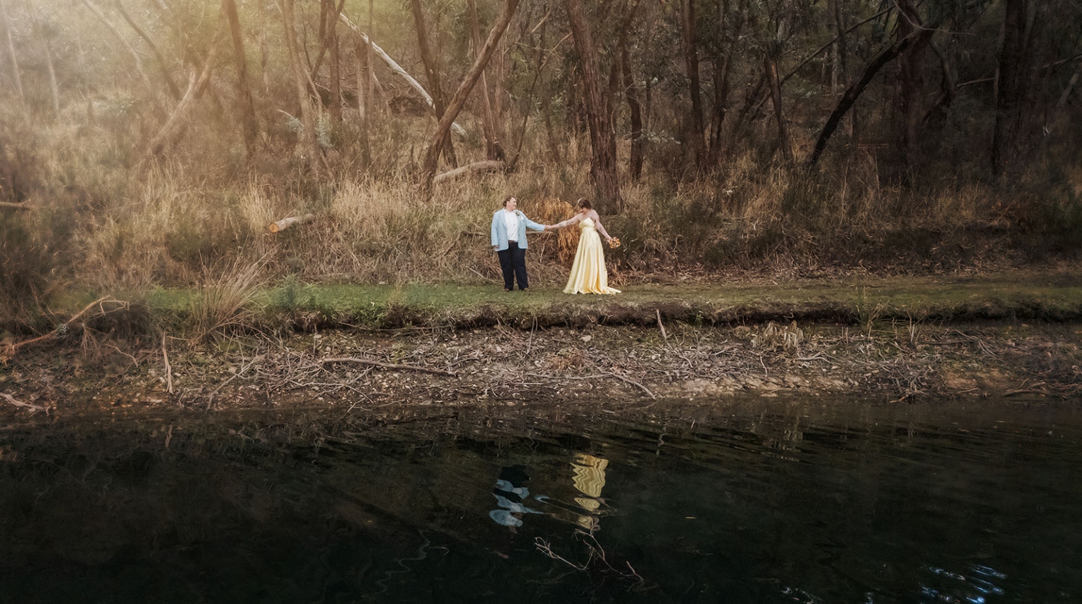 tiny house on the prairie wedding - lauren & bek 42 Formal couple portrait by forest creek in golden wedding light.