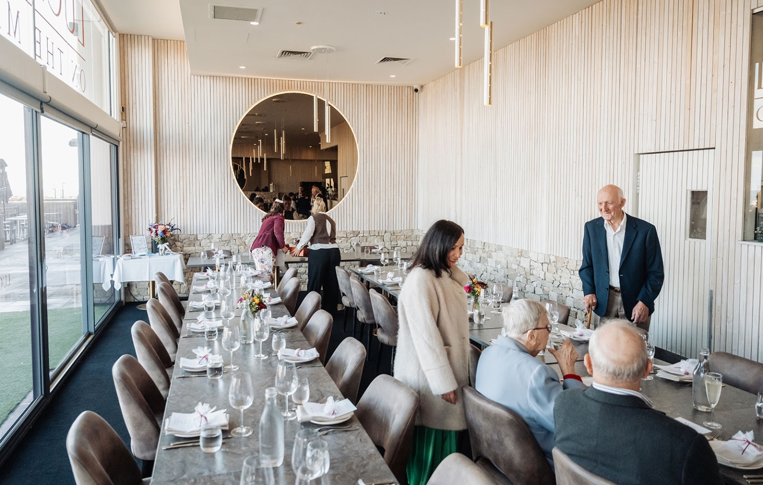 sa marriage office wedding – melissa & kyran 214 Elegant formal event dining room with long tables, floral centerpieces, and guests.