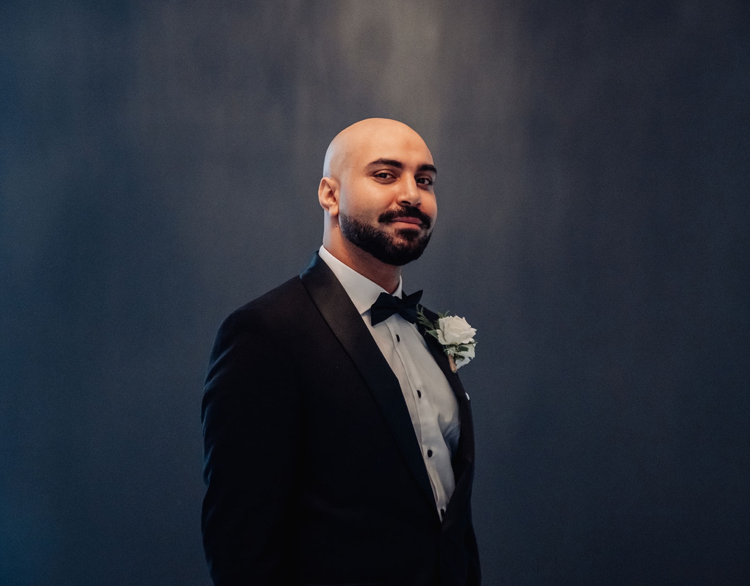st george & st shenouda coptic church wedding - carmina & bill 16 Elegant groom in black tuxedo with boutonniere formal portrait.