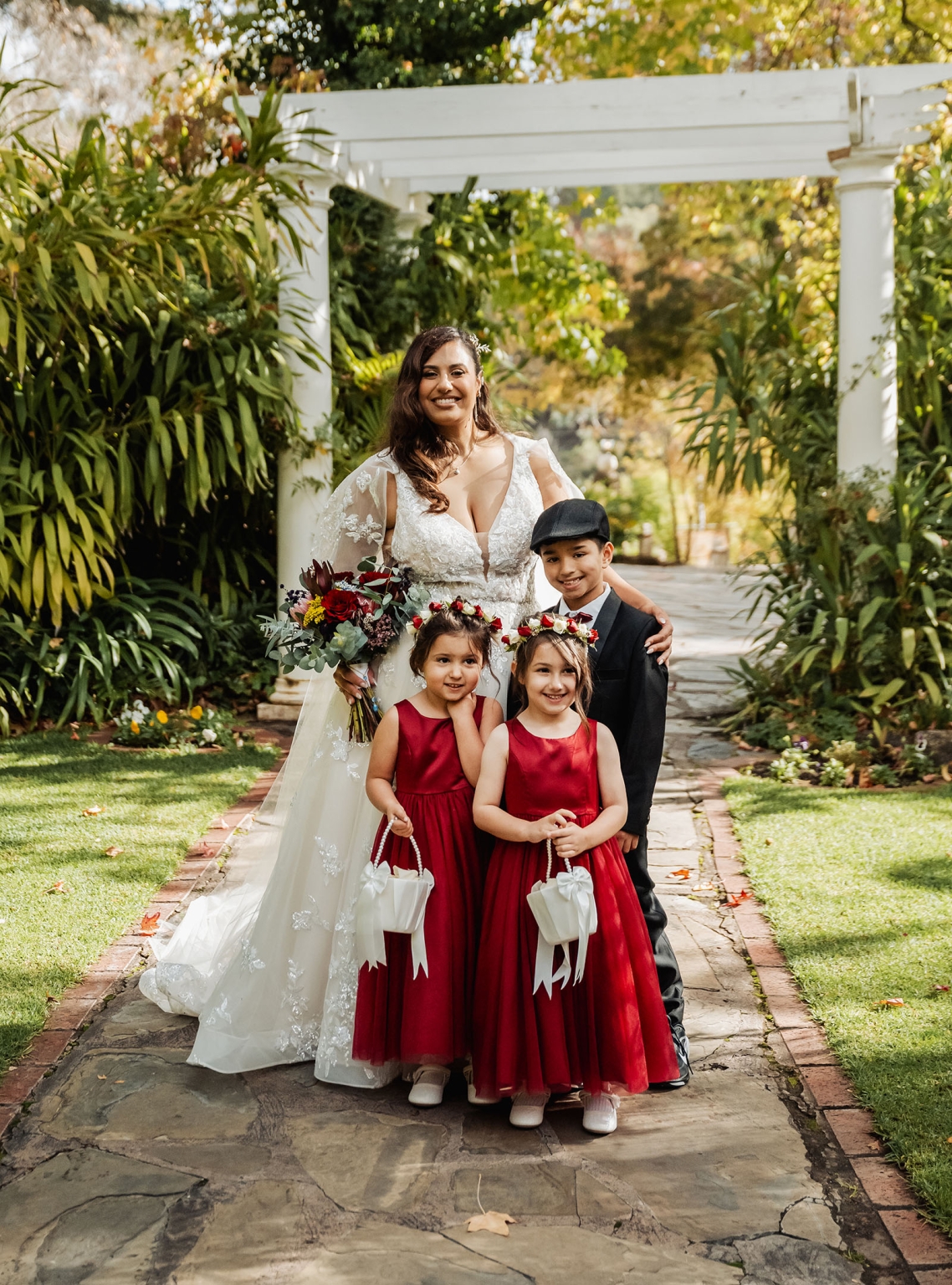 basket range wedding at the manor - leah & wes 34 Bride with flower girls and ring bearer in garden wedding portrait.