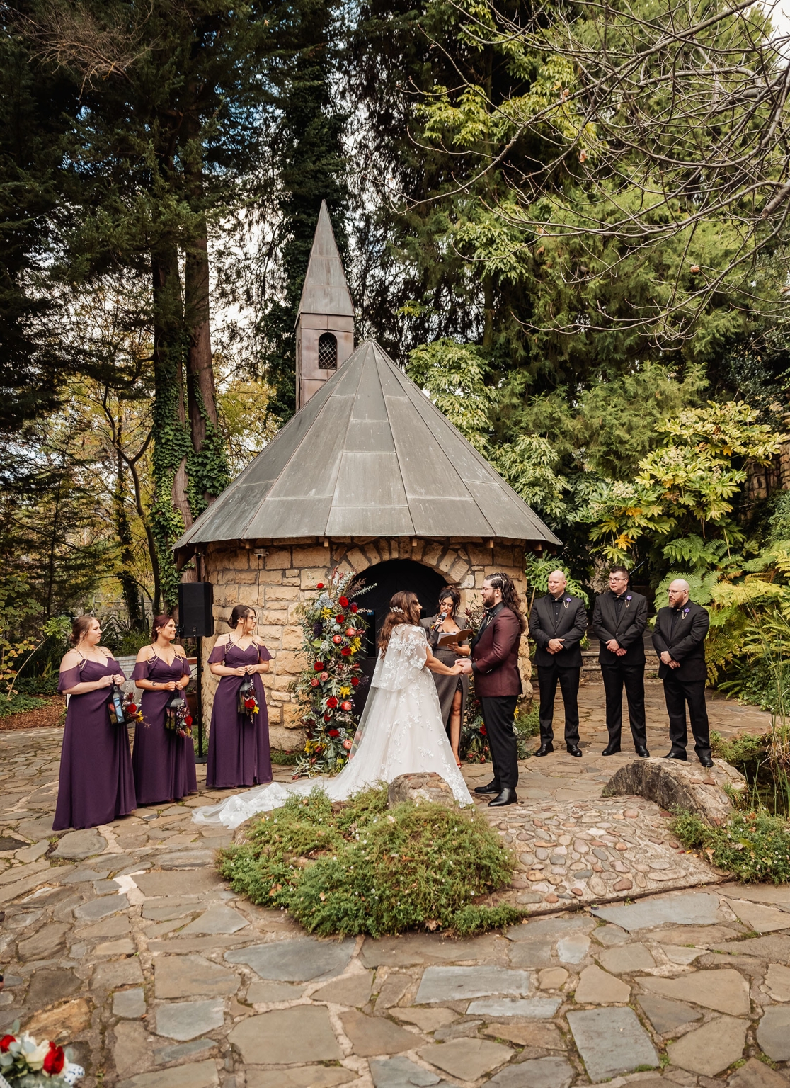 basket range wedding at the manor - leah & wes 47 Garden wedding ceremony at a rustic stone chapel with bride, groom, and bridal party.