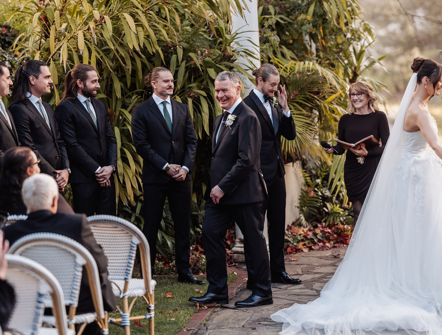 the manor wedding - crystal & mackenzie 49 Joyful garden wedding ceremony with bride, groom, officiant, and guests.