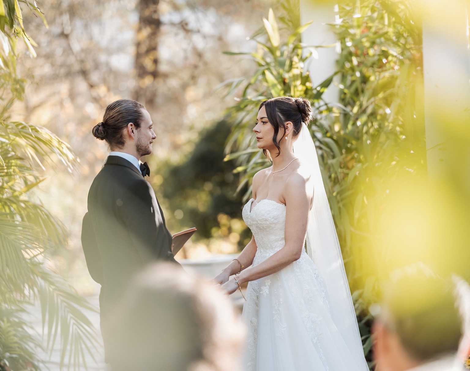 the manor wedding - crystal & mackenzie 50 Bride and groom exchanging vows at a romantic outdoor garden wedding ceremony.