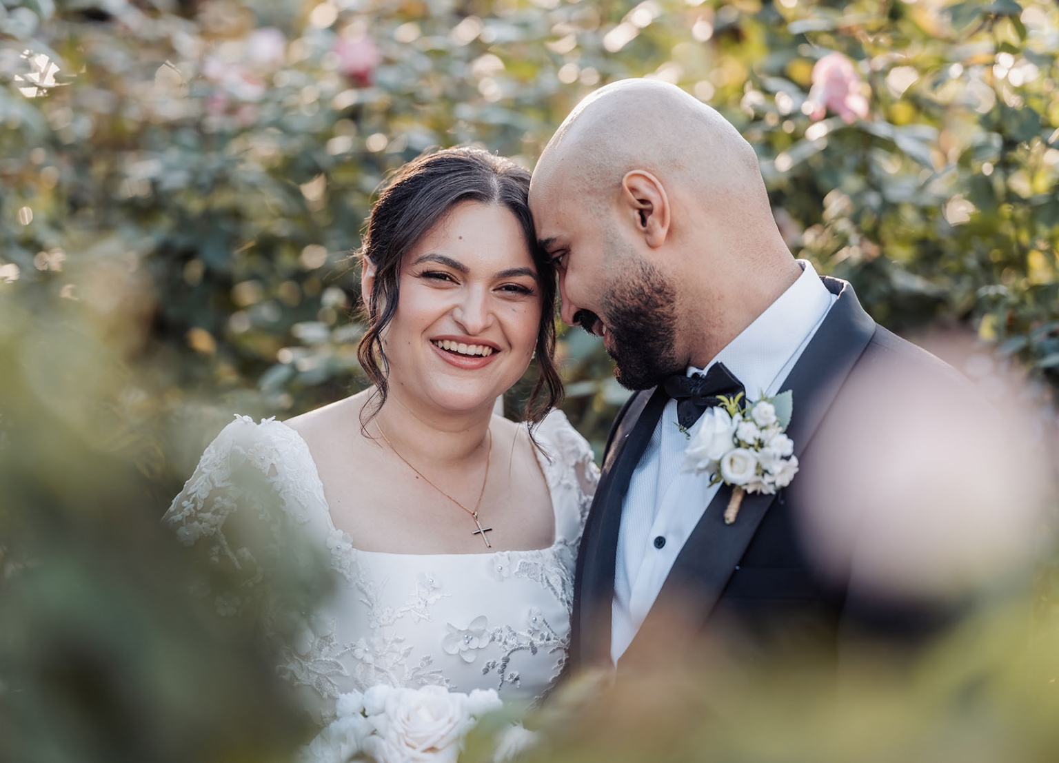 st george & st shenouda coptic church wedding - carmina & bill 56 Joyful bride and groom wedding portrait in a romantic garden setting.