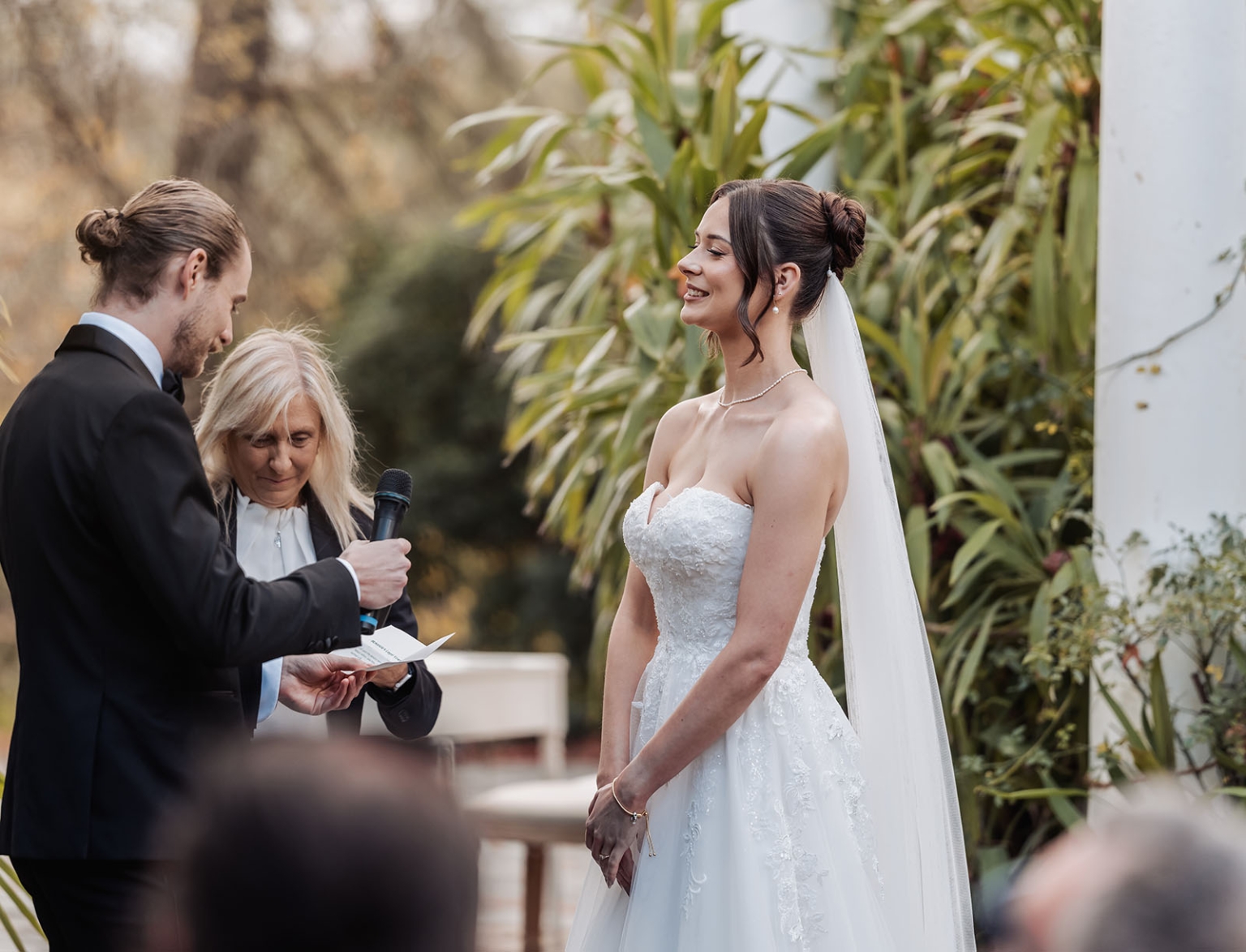 the manor wedding - crystal & mackenzie 54 Bride and groom exchange vows during a romantic garden wedding ceremony.