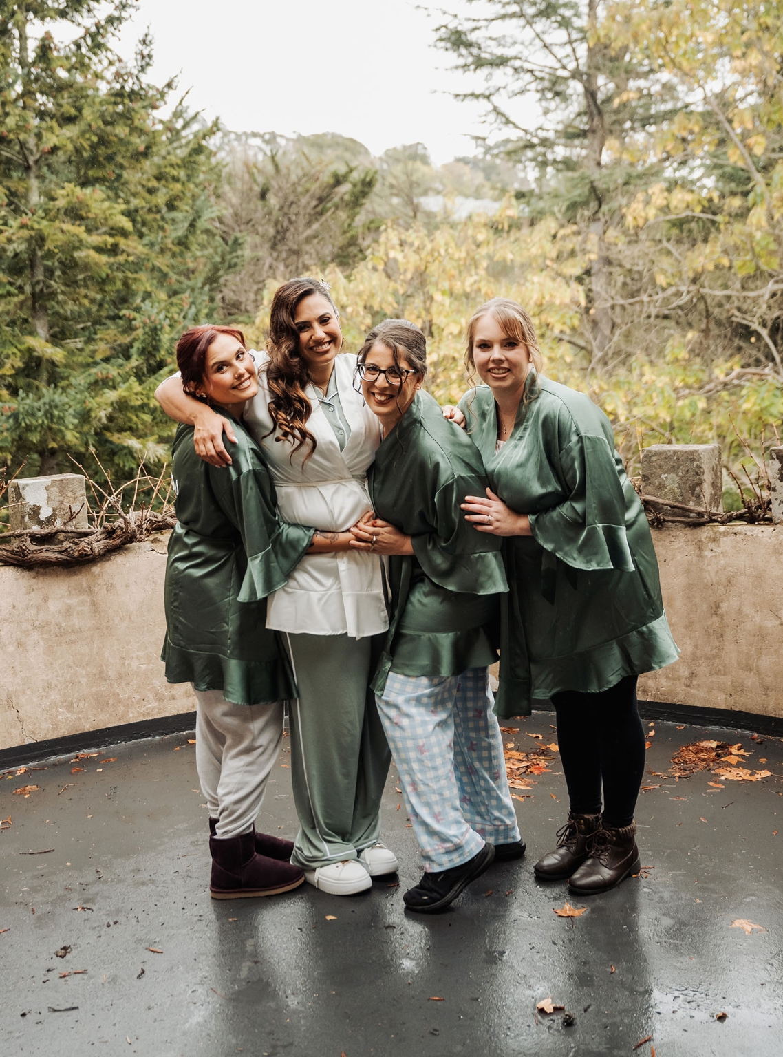 basket range wedding at the manor - leah & wes 5 Bride and bridal party in sage green robes on rainy wedding morning.