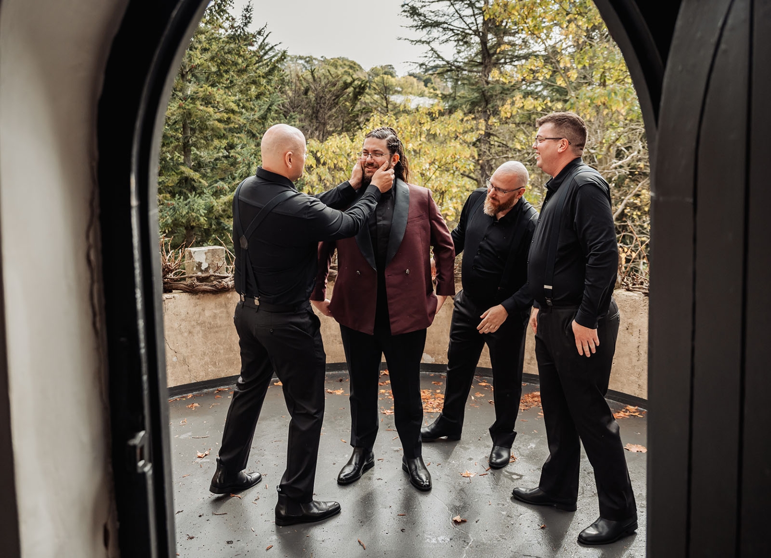 basket range wedding at the manor - leah & wes 23 Groom and groomsmen share candid wedding preparation moment on autumn terrace.