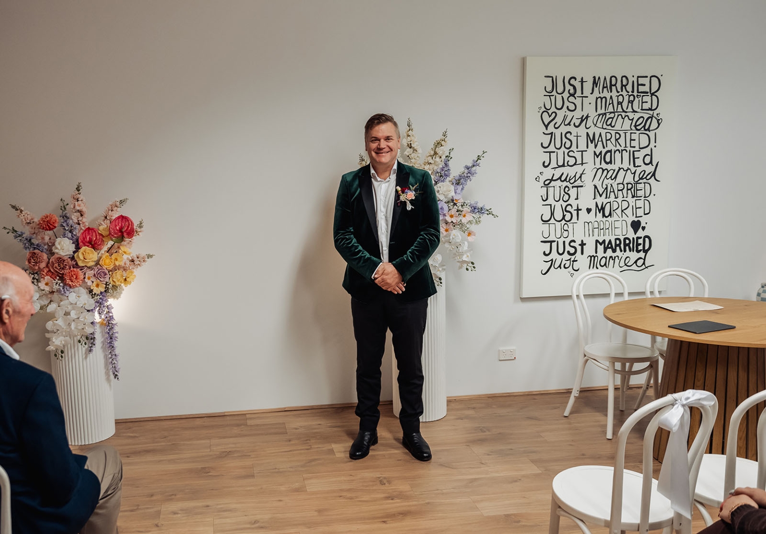 sa marriage office wedding – melissa & kyran 193 Groom in emerald blazer at intimate wedding ceremony with pastel floral arrangements.