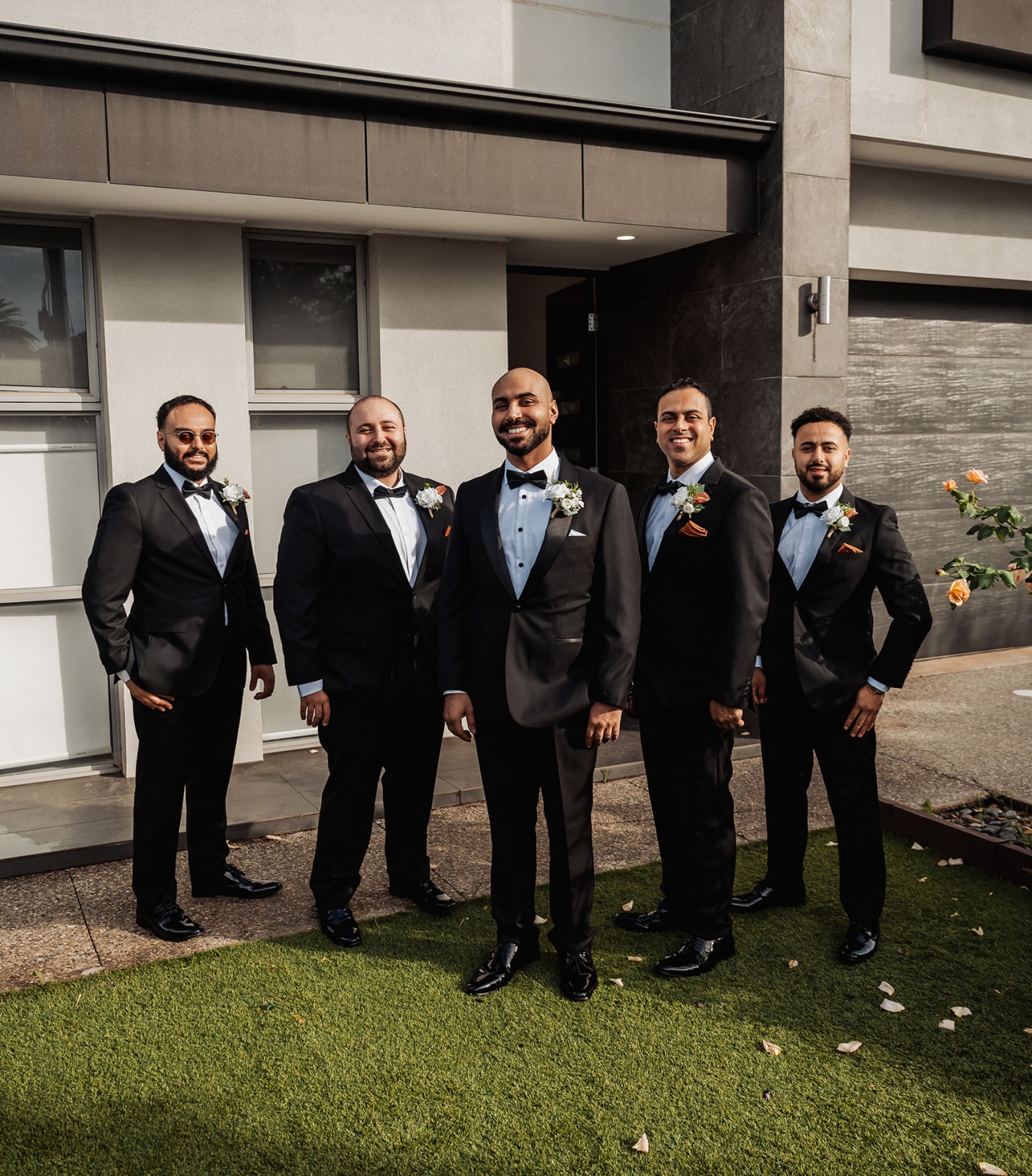 st george & st shenouda coptic church wedding - carmina & bill 11 Groom and groomsmen in black tuxedos pose for wedding portrait.