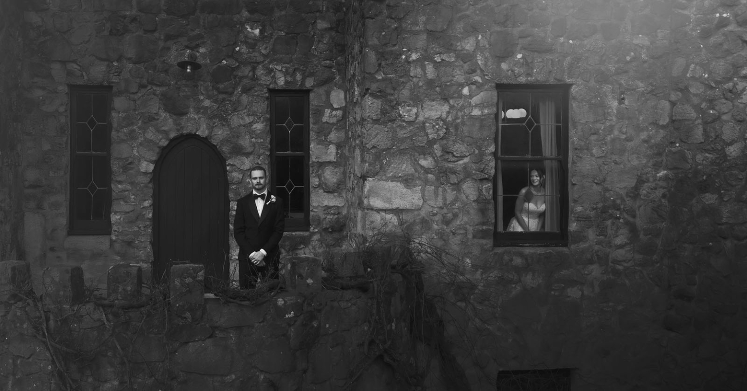 the manor wedding - crystal & mackenzie 36 Black-and-white bride and groom portrait at historic stone chapel.