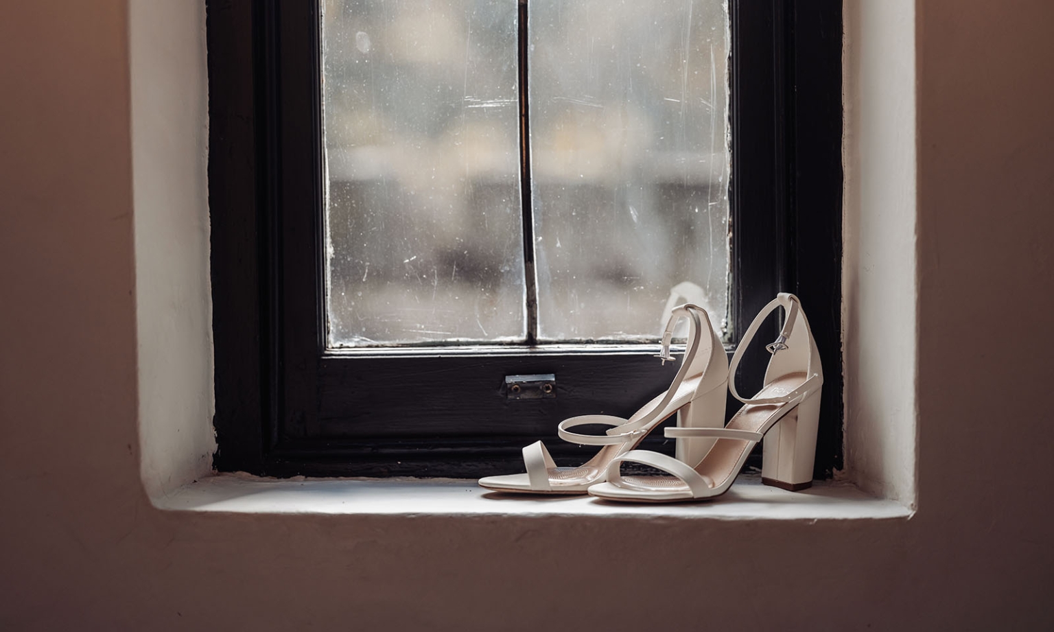 the manor wedding - crystal & mackenzie 14 Ivory bridal block heel sandals on a windowsill for elegant wedding day style.