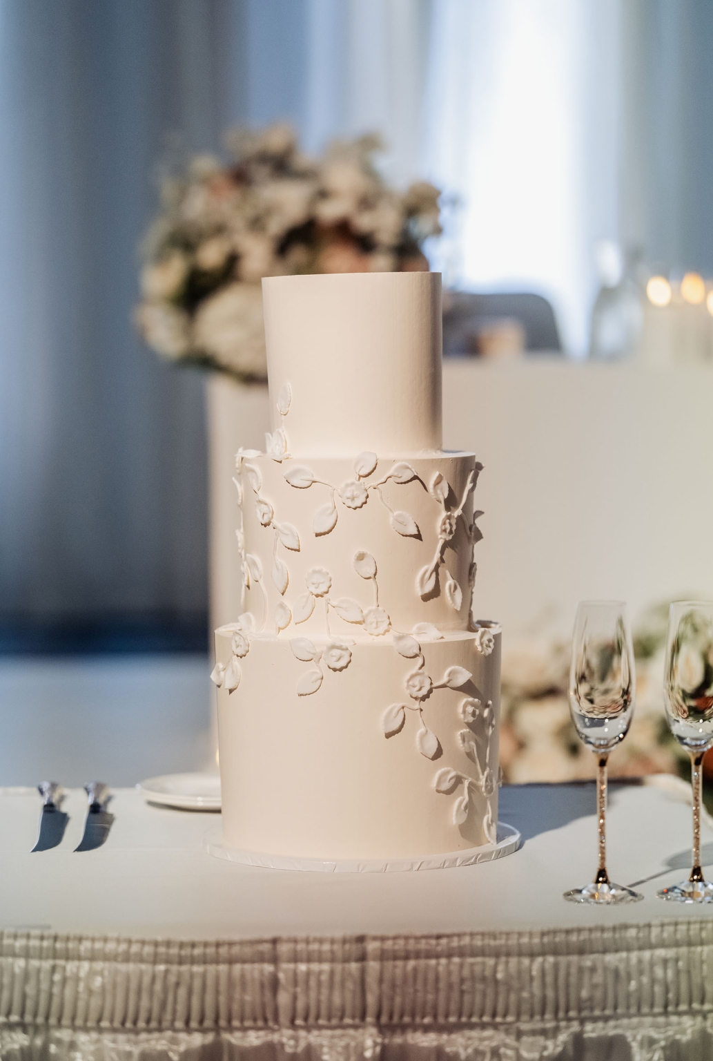 st george & st shenouda coptic church wedding - carmina & bill 80 Ivory three-tier wedding cake with delicate floral icing at elegant reception.
