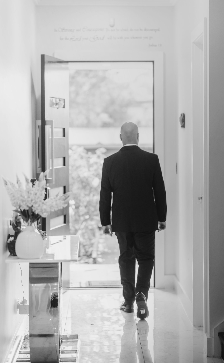 st george & st shenouda coptic church wedding - carmina & bill 8 Businessman leaving modern luxury home hallway through open front door.