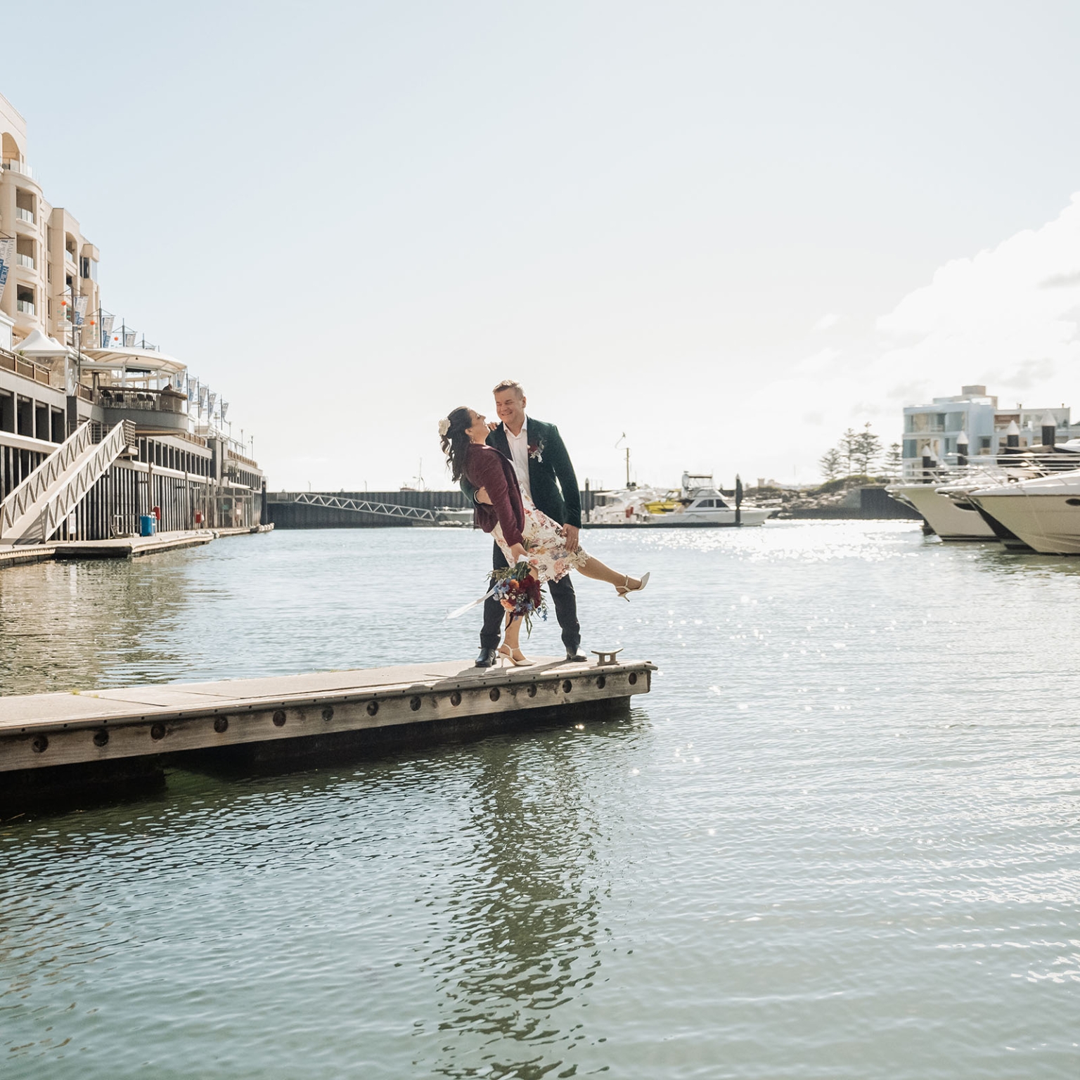 sa marriage office wedding – melissa & kyran 218 Marina wedding couple posing on dock with boats and waterfront views.