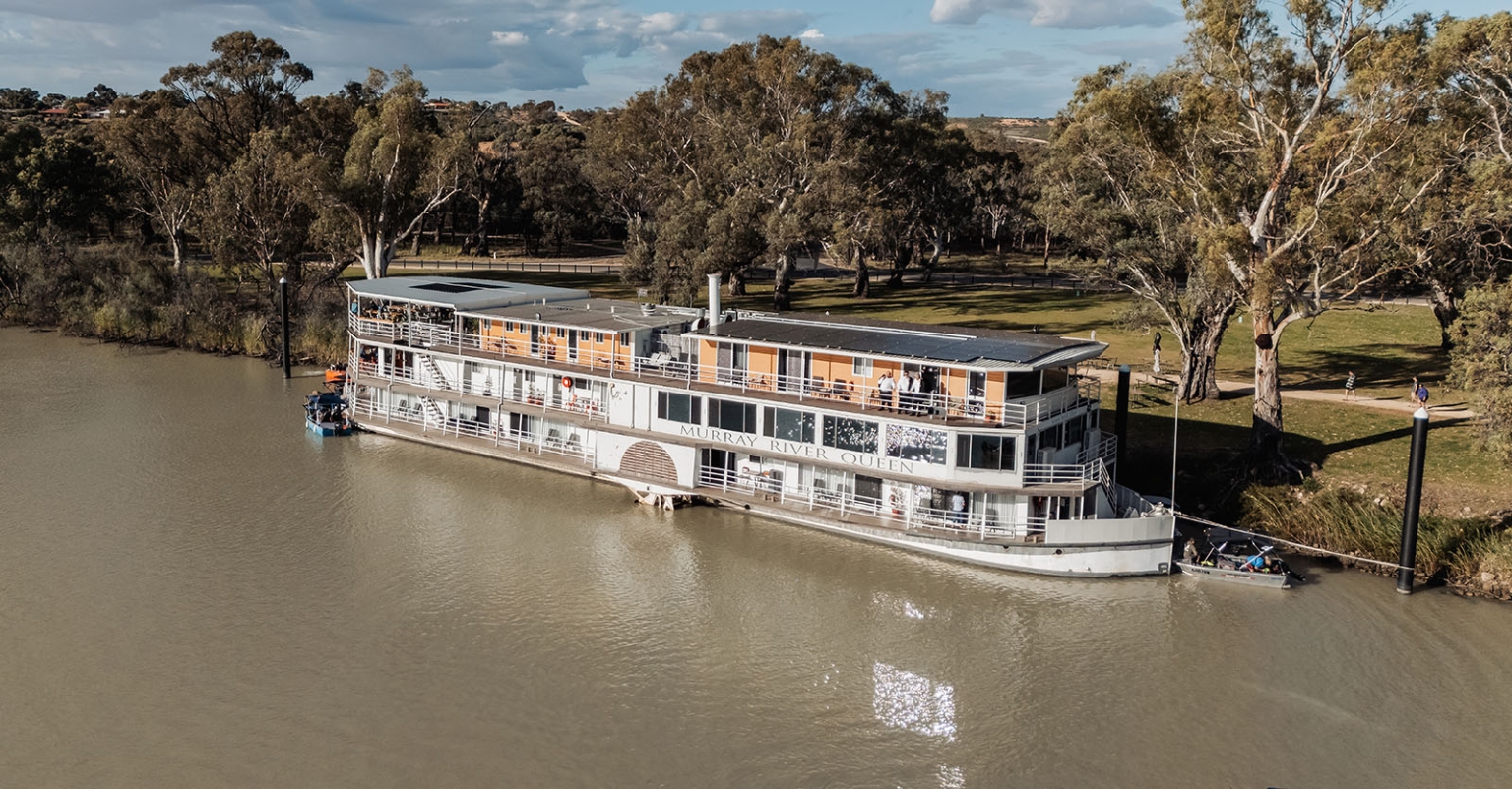 loxton's st peter's church wedding - madeline & brayden 6 Murray River Queen riverboat moored on a scenic tree-lined riverbank.