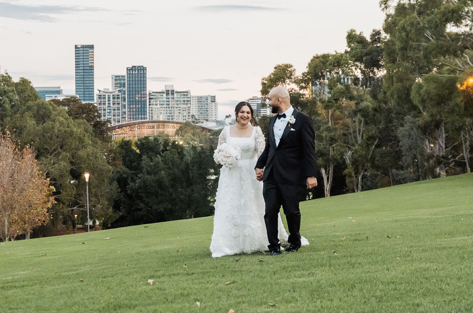 st george & st shenouda coptic church wedding - carmina & bill 75 Newlywed couple in park wedding portrait with city skyline at sunset.