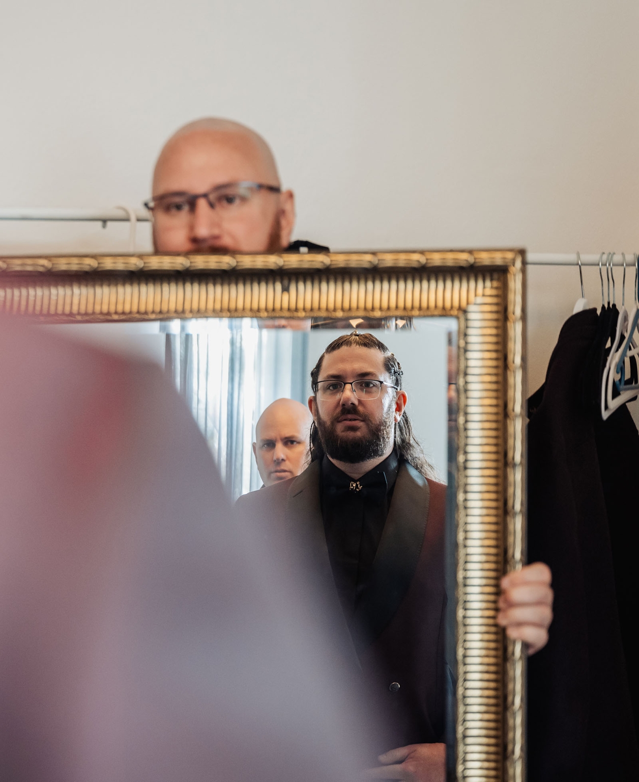 basket range wedding at the manor - leah & wes 22 Men reflected in ornate gold mirror in backstage dressing room.