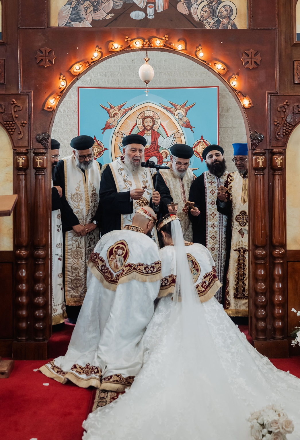 st george & st shenouda coptic church wedding - carmina & bill 51 Orthodox wedding blessing ceremony with bride, groom, and priests in ornate church.