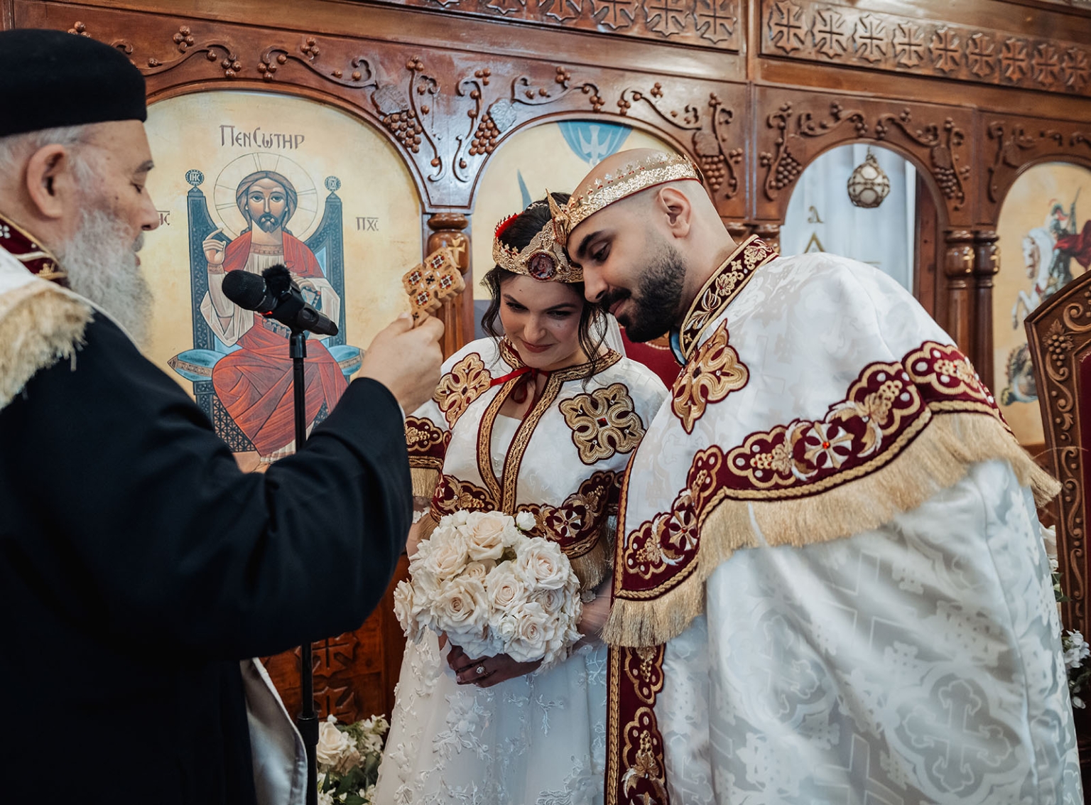 st george & st shenouda coptic church wedding - carmina & bill 47 Orthodox wedding ceremony with priest blessing crowned bride and groom in church.