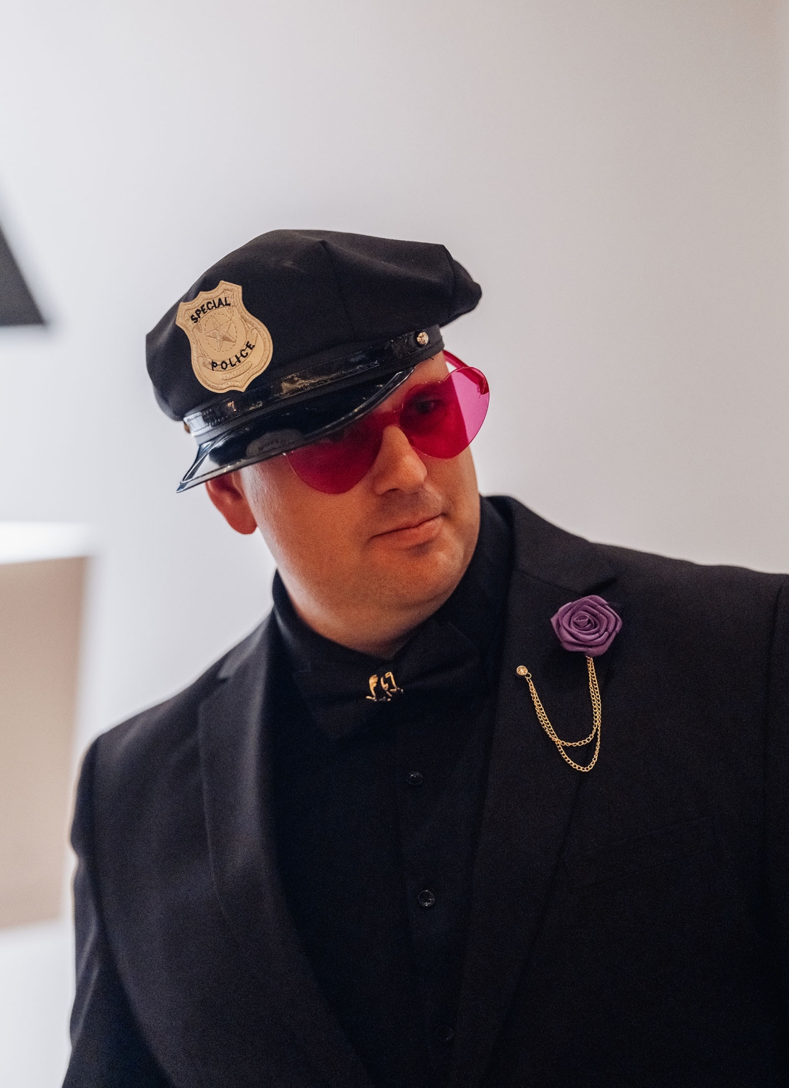 basket range wedding at the manor - leah & wes 68 Stylish man in police costume with red sunglasses and purple rose.