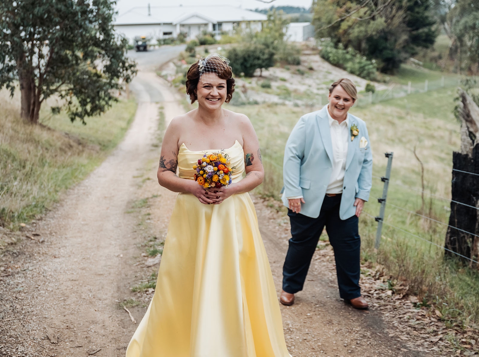 tiny house on the prairie wedding - lauren & bek 13 Rustic countryside wedding portrait with yellow bridal gown, bouquet, and blue blazer.