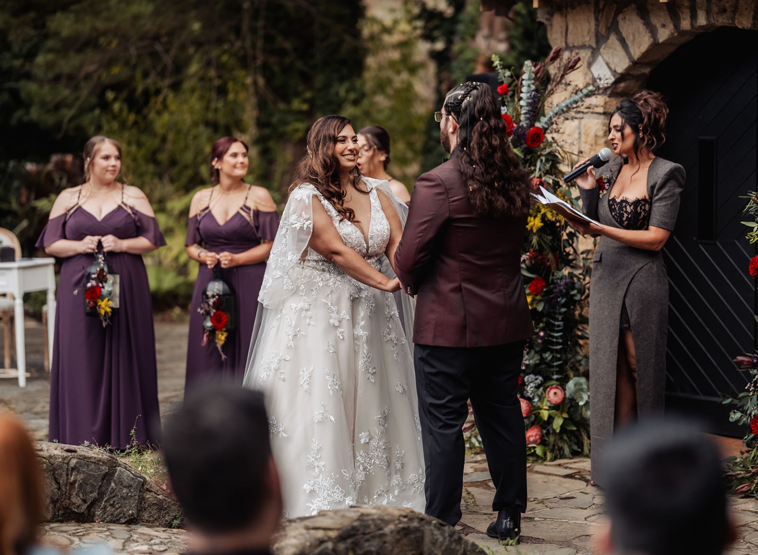 basket range wedding at the manor - leah & wes 46 Rustic garden wedding ceremony with bride, groom, bridesmaids, and floral stone arch.