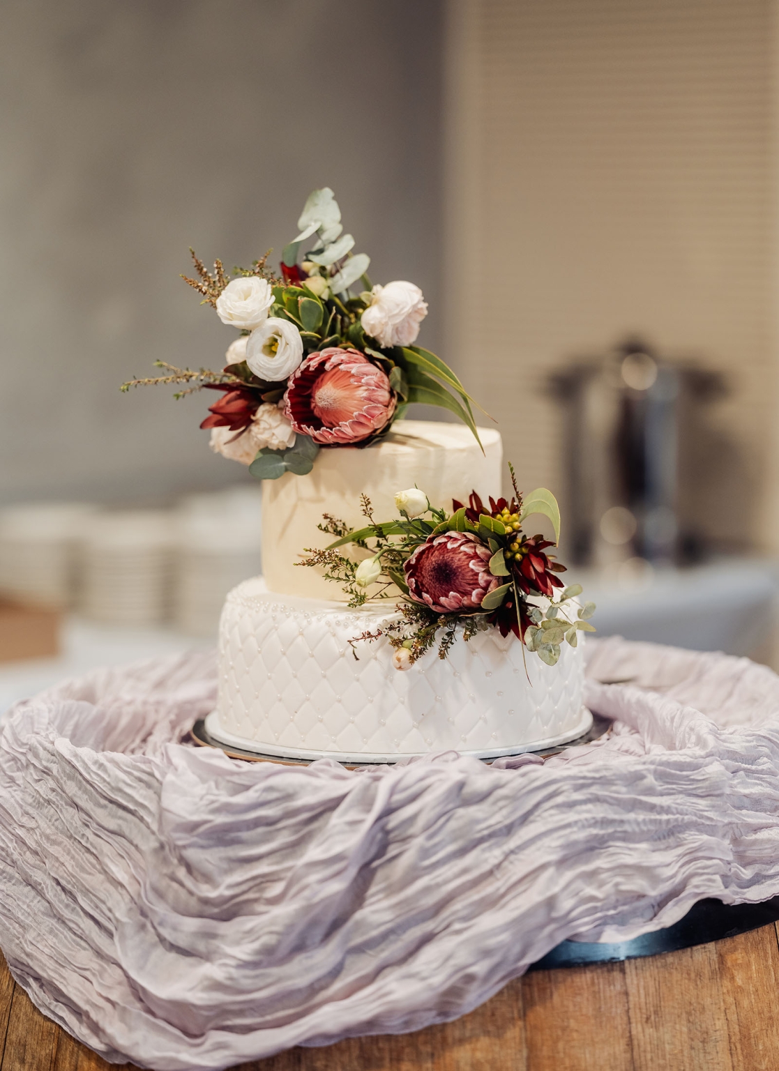 loxton's st peter's church wedding - madeline & brayden 57 Two-tier floral wedding cake with quilted fondant and burgundy blooms.