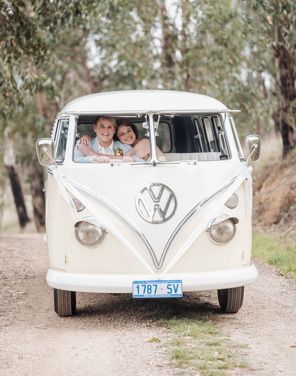 tiny house on the prairie wedding - lauren & bek 17 Vintage VW camper wedding portrait with smiling couple in rustic woodland setting.